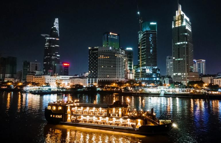 Savor delicious food and watch the nighttime landscape along the Saigon River on a dinner cruise