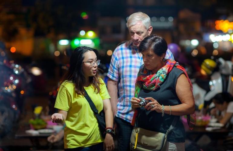 A night food tour in Ho Chi Minh City helps you learn about stories behind dishes