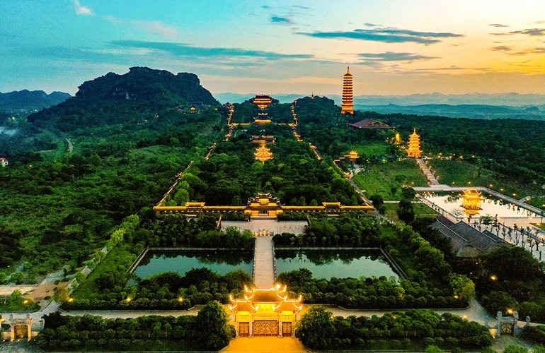 Bai Dinh Pagoda is brightly lit at night amidst the majestic beauty of the forest