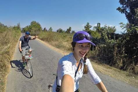 Tourists cycle on country roads in Indein village.