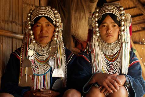Akha women, adorned with distinctive brocade hats featuring coins, silver, and intricate embroidery