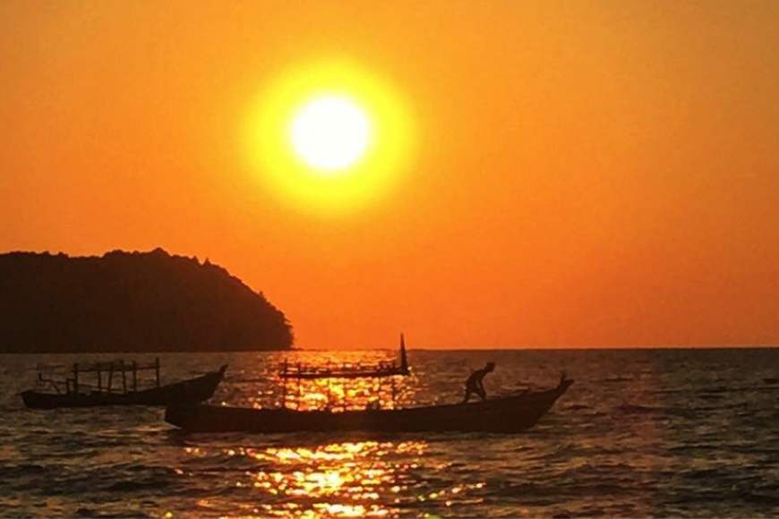 Witness the breathtaking spectacle of a vibrant sunset painting the sky with hues of gold, orange, and pink in Ngapali Beach