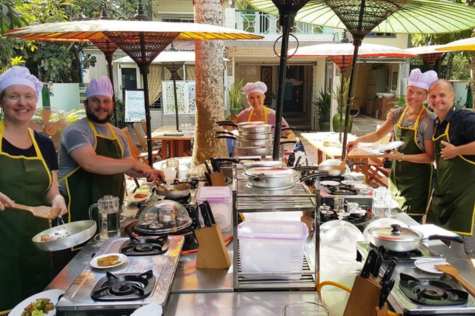 Local people are guiding tourists to cook local dishes.