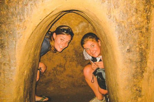 Tourists explore tunnels in Cu Chi tunnels.