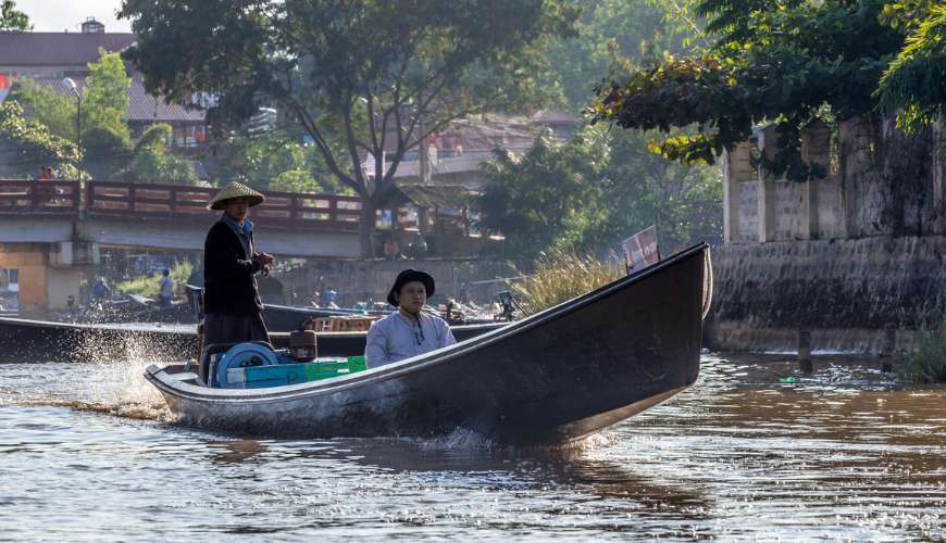 Tourists row to explore Inle lake.